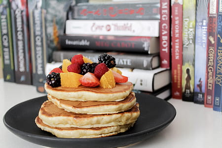 Pancake on Black Plate Near Books thumbnail