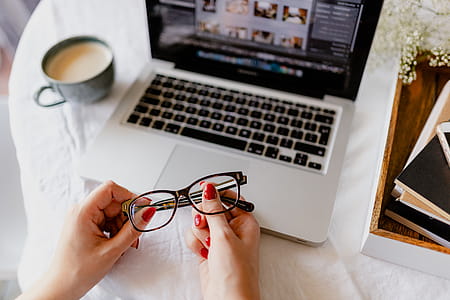 A woman works at a desk with a laptop and a cup of coffee thumbnail