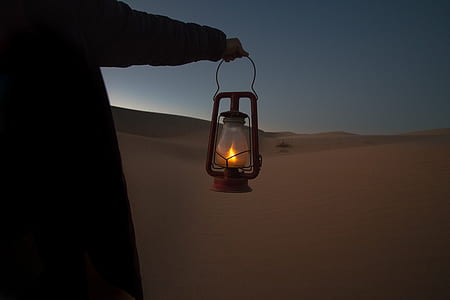 person holding lighted cold blast lantern thumbnail