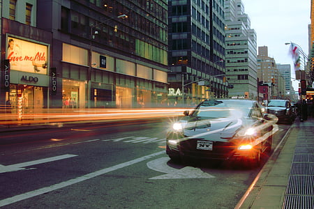 black coupe parked on roadside in timelapse photography thumbnail