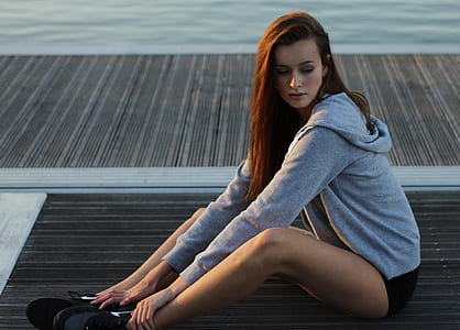 photo of woman sitting on dock thumbnail