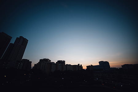 silhouette of cityscape under clear sky thumbnail