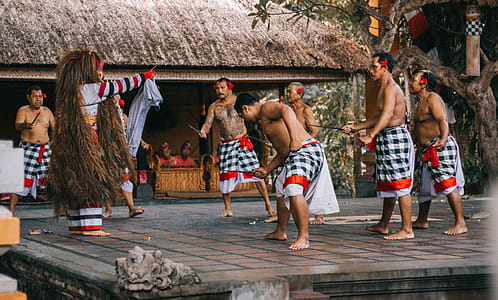 Men Wearing White and Black Checked Sarong Standing on Stage thumbnail