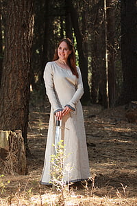 woman in grey scoop-neck long-sleeved dress holding sword while smiling thumbnail