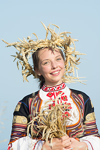 smiling woman wearing wheat crown and holding bouquet thumbnail