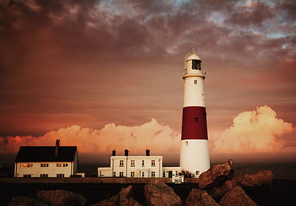 lighthouse on cliff with clouds in background thumbnail