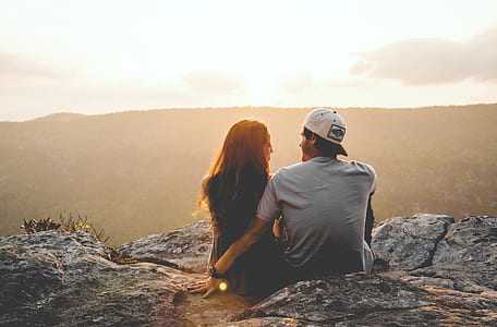 man and woman sitting on mountain edge thumbnail
