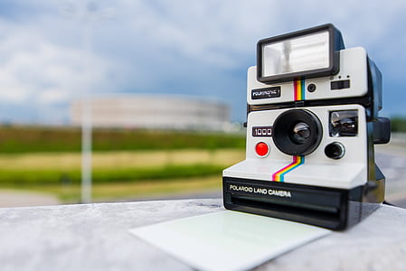 Tilt Shift Photography of Polaroid Land Camera on White Table thumbnail