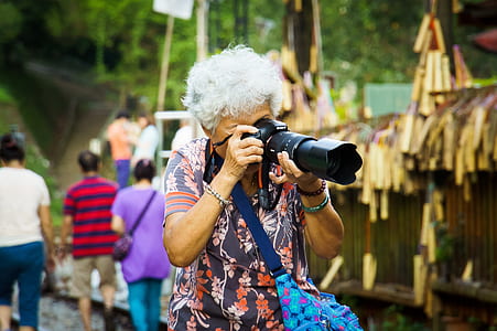 woman taking picture using DSLR camera thumbnail