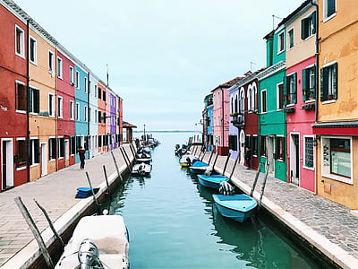 assorted boats between houses thumbnail