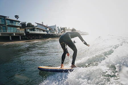 man on white surfboard during daytime thumbnail