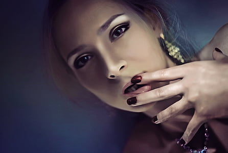 selective focus photography of woman with her hands on her lips thumbnail