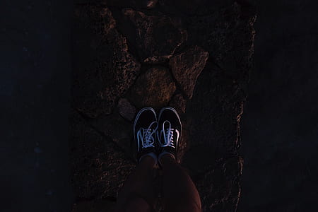 person wearing low-top sneakers on area rug thumbnail
