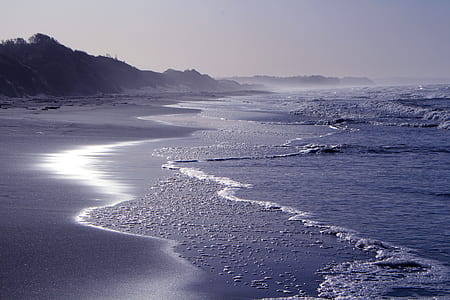 photo of sea wave near gray mountain thumbnail