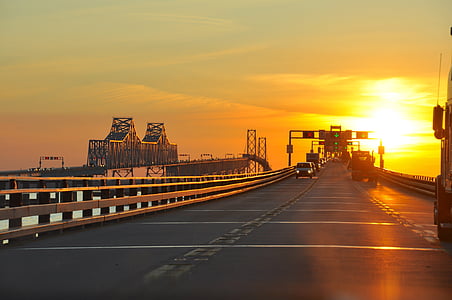 vehicle moving on road during golden hour thumbnail