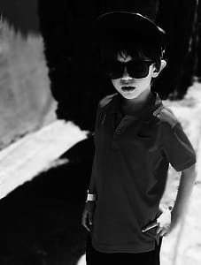 Grayscale Photography of Boy Wearing Polo Shirt and Sunglasses thumbnail