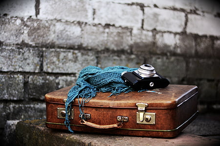black camera on brown briefcase thumbnail