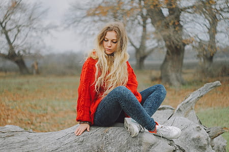 Woman in Red Sweater Sitting on Cutted Tree thumbnail