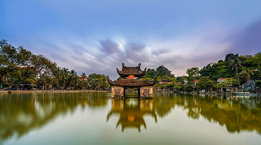 brown concrete house on center of lake at daytime thumbnail