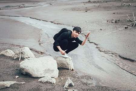 Man Carrying Backpack Near River thumbnail
