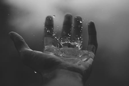 water drops above left human palm photo thumbnail