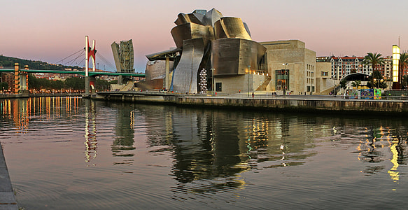 gray concrete building near body of water thumbnail