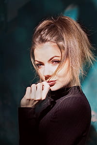 woman in black long-sleeved top posing for photo thumbnail