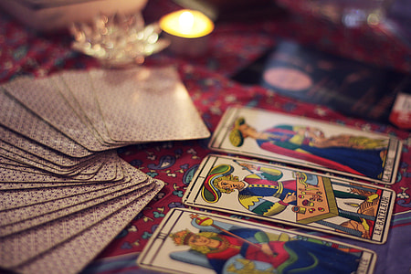 tarot cards on red floral textile thumbnail