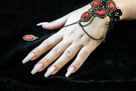 person wearing black and red gemstone encrusted bracelet thumbnail
