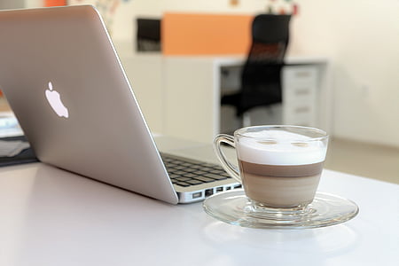 selective focus photography of turned-on silver MacBook on table beside cup of coffee thumbnail