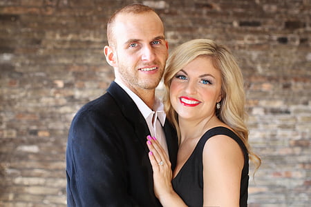 man in black formal suit and woman in black sleeveless dress thumbnail