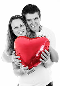 selective color photo of couple holding red heart balloon thumbnail