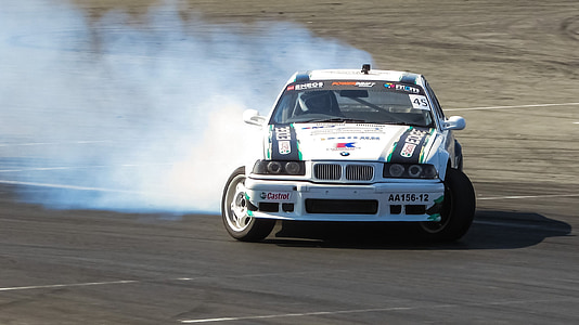 car drifting on race track during daytime thumbnail