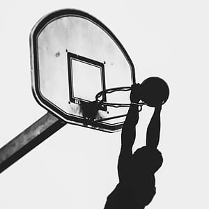 silhouette photography of man dunking basketball thumbnail