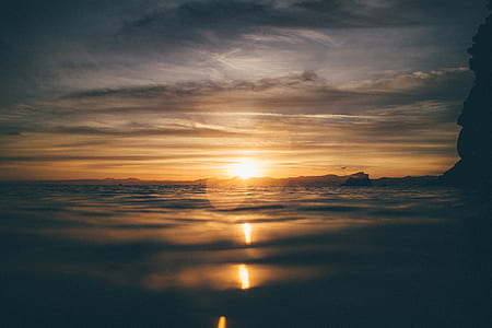 sunset over water photo thumbnail