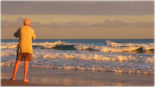 man standing facing shoreline thumbnail