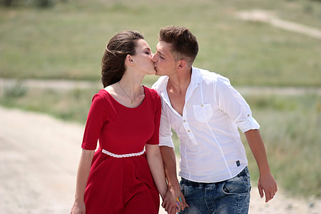 couple kissing each other on road during daytime thumbnail