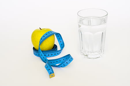 yellow fruit on tape measure near glass filled with water thumbnail