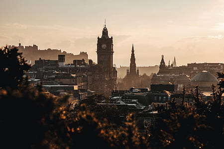 tower clock surrounded by buildings thumbnail