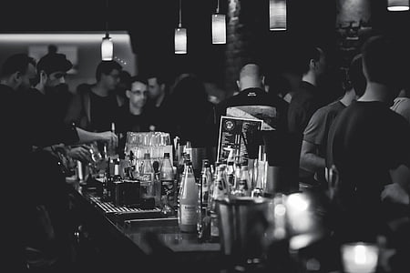 grayscale photo of group of people at the bar thumbnail