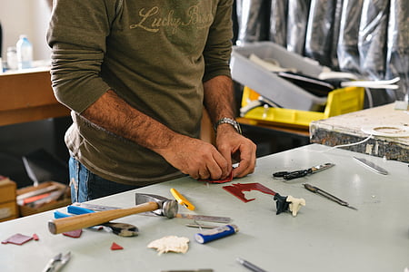 person holding plastic model thumbnail