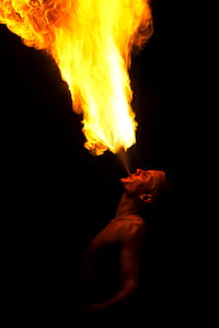 topless man playing fire during daytime thumbnail