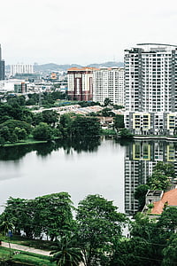 high-angle photography of concrete buildings near body of water at daytime thumbnail