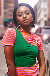 Woman Wearing Orange and Green Shirt thumbnail