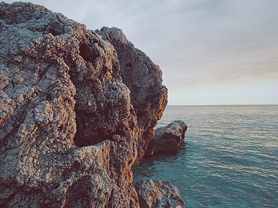 monolith beside body of water thumbnail