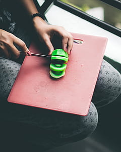 person slicing kiwi fruit thumbnail
