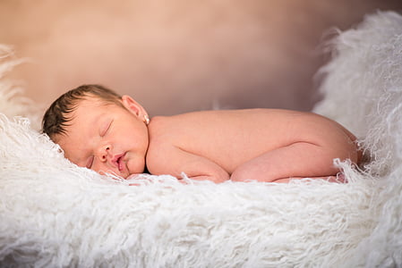 baby sleeping on white textile thumbnail
