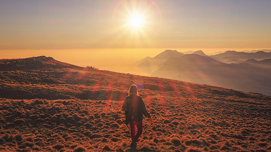 woman walking looking at sun thumbnail