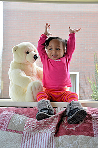 toddler sitting on table beside polar bear plush toy thumbnail
