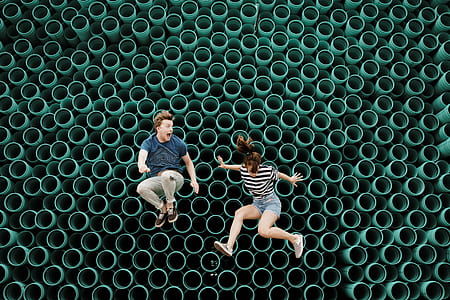 boy jumping with his girl during daytime thumbnail